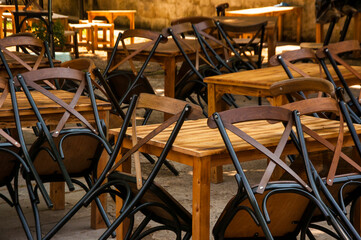 Wooden chairs and tables in empty cafe