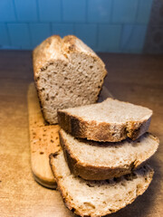 A sliced loaf of bread sitting on top of a wooden cutting board