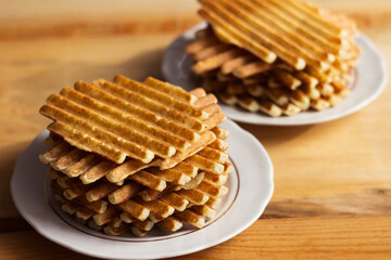 Lots of potato waffles with sauce and parsley, delicious food