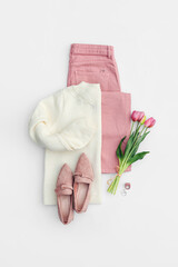 Fashion spring outfit. White  jumper with pale pink  jeans and loafers. Women's stylish and elegant...