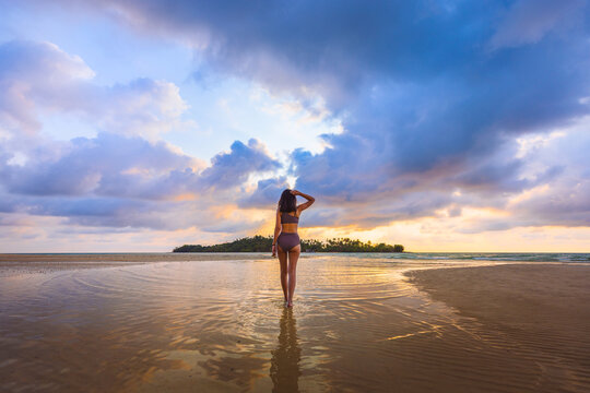 Happy traveler asian woman with bikini relax on sea Klong Rahan beach in sunset at Koh Kood Trat Thailand Summer travel holiday vacation concept