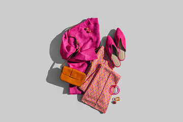Fashion spring or autumn outfit. Pink jumper and shoes with pants,  handbag. Women's stylish and elegant clothes with accessory and jewelry. Fashionable look. Flat lay, top view, overhead.