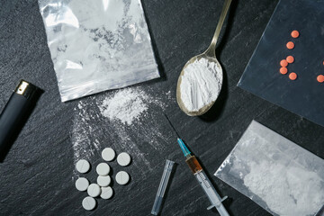 Flat lay composition with different drugs on black textured table