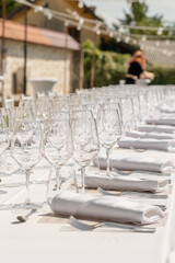 Served wedding table with plates, white chairs, napkins and wine glasses