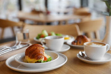 Delicious breakfast served on wooden table in cafe
