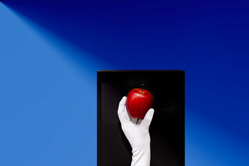 art in a box, apple and hand in white glove