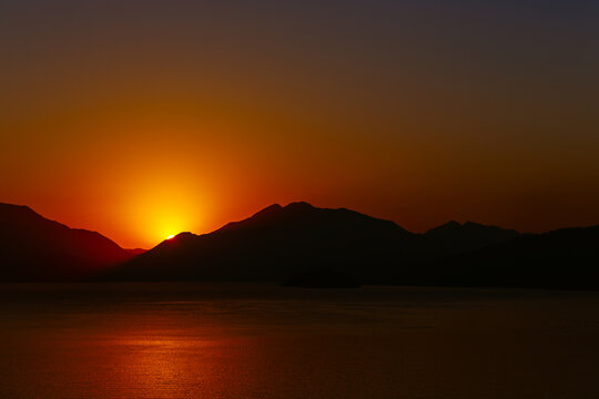 Orange sunrise over coastline, Marmaris, Mugla, Turkey