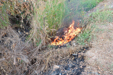 Flames burning at garbage piles.
