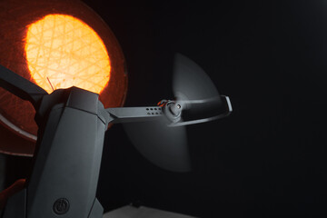 quadcopter in a dark room illuminated by red light in a person's hand simulation of flight and...