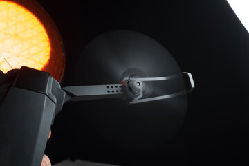 quadcopter in a dark room illuminated by red light in a person's hand simulation of flight and...