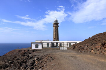 El Faro de Punta Orchilla lighthouse with red volcanic scenery in summer, El Hierro, Canary Islands, Spain