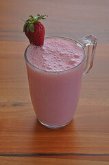 A glass of strawberry milk, healthy strawberry smoothie. 