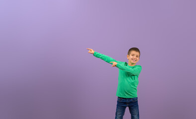 Portrait of young businessman pointing at empty space and marketing new product on purple background