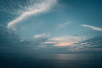 The blue sky in the early morning meets the calm, serene ocean, creating a tranquil, peaceful view....