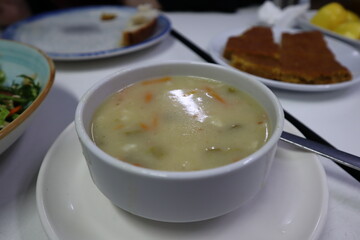 Bowl of fish soup with vegetables