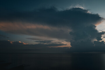 The blue sky in the early morning meets the calm, serene ocean, creating a tranquil, peaceful view....