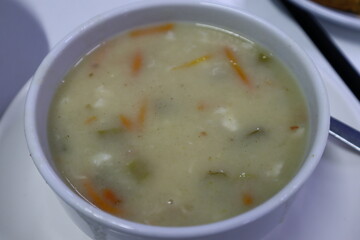 Bowl of fish soup with vegetables