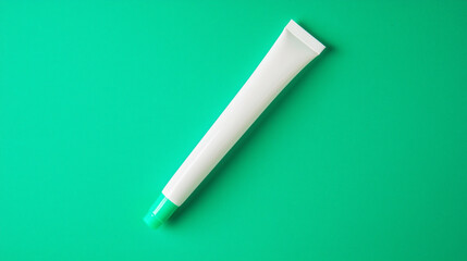 Mockup of a white cosmetic tube with a green cap on a solid green background


