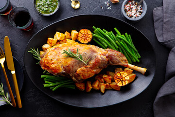 Roasted lamb leg with green bean and red wine. Grey background. Close up. Top view. © annapustynnikova