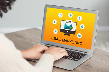 Email marketing. Woman using laptop at table, closeup