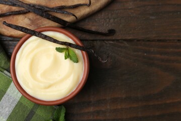 Tasty vanilla pudding, mint and pods on wooden table, flat lay. Space for text