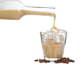 Pouring coffee cream liqueur from bottle into glass isolated on white