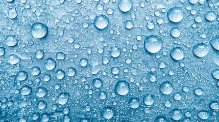 A stunning close-up of translucent water droplets scattered across a textured blue surface, creating a mesmerizing visual effect with unique patterns