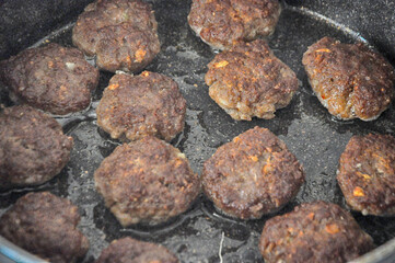 Meatball frying in pan. Turkish kofte