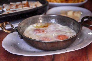 Fried eggs in a pan. Turkish breakfast food.