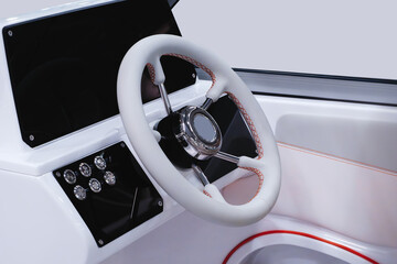 A white boat with a steering wheel and a black dashboard
