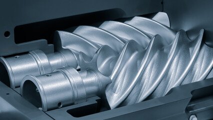 Silver gear with a pointed end and a spiral shape. The spiral shape is very sharp and the gear is...
