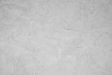 A white wall with a grey texture. The wall is empty and has no decoration. The wall is plain and simple