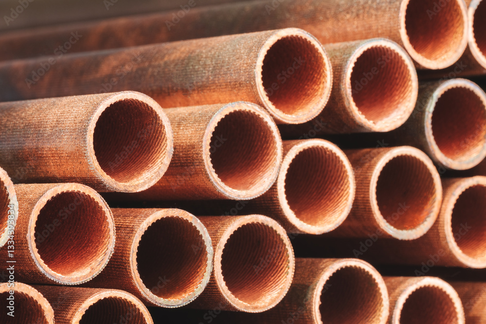 Poster a row of pipes with a brownish color. the pipes are stacked on top of each other. industrial concept