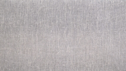 White fabric with a pattern of small squares as a textured background. All the squares are different sizes and are arranged randomly