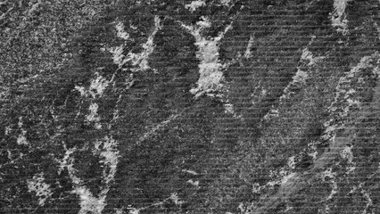 Close up of black processed stone surface with lots of texture and pattern. Textured background has rough textured surface.