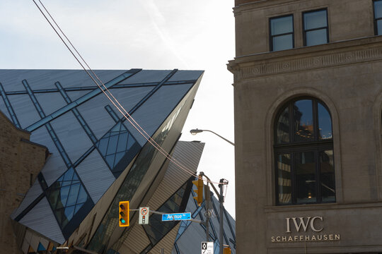 looking west on Bloor St W from Queen's Park/Avenue Rd to imposing deconstructivist building designed by Daniel Libeskind (Royal Ontario Museum) in Toronto, Canada (IWC Schaffhausen Boutique)