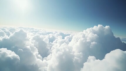 Breathtaking aerial panorama featuring a vast expanse of fluffy cumulus clouds under a bright, expansive blue sky on a sunny day.