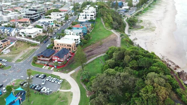Aerial view passing over Miami hill after cyclone Alfred, ending with a view towards Miami beach and Surfers Paradise in the horizon. Gold Coast, Australia.