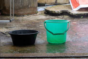 Naklejka premium Collect rainwater in a bucket