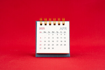 April Mini calendar for 2025 year on red background.