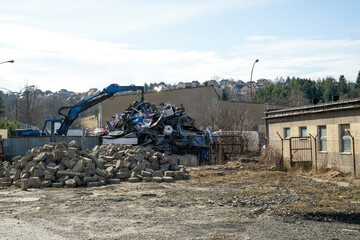Scrap Yard with Excavator Sorting Metal