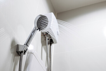 A close-up of a working shower. Concept of energy efficient technologies, modern comfort and energy...