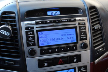 Obraz premium Old car multimedia system on dashboard. SUV control panel. Classic Vehicle Conditioner and climate control. Radio on control panel system in car. Multimedia control system.