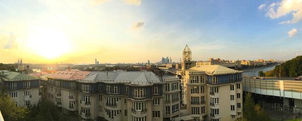 City skyline at sunset Rows of historic buildings silhouetted under a warm evening sky.