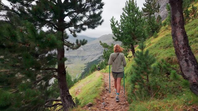 Woman hiking through Ordesa Valley in Monte Perdido National Park in Pyrenees.