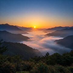 Obraz premium Capture the beauty of a tranquil sunrise over misty mountains, where soft, golden sunlight gently lights up the valleys below. This image portrays the calmness of nature and the breathta