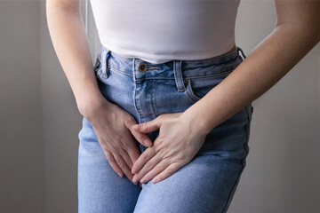 Female health concept. Woman hands holding crotch suffering from pain, burning, itching symptoms of...
