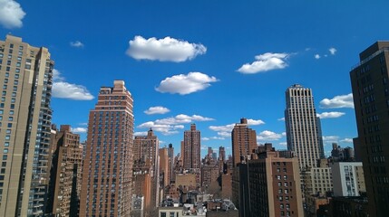 Obraz premium Sunny Cityscape, Manhattan rooftop view, buildings, clouds, summer