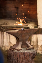 Anvil and hammer in a forge.