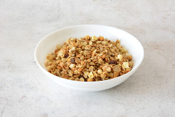 A bowl of delicious homemade granola with apples and raisins
